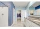 Bright bathroom featuring granite vanity, double sinks, walk-in shower, and walk-in closet at 11279 Amber Ridge Dr, Zellwood, FL 32798