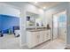 Bright bathroom with double granite vanity, ensuite bathroom, tile floor and view to Primary bedroom at 11279 Amber Ridge Dr, Zellwood, FL 32798