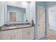 Bright bathroom with a double sink vanity and granite countertops at 11279 Amber Ridge Dr, Zellwood, FL 32798