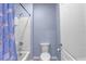 Clean bathroom featuring a shower-tub combo with dolphin-themed curtain at 11279 Amber Ridge Dr, Zellwood, FL 32798