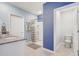 Bathroom features granite vanity, tiled floor, white walls, and walk-in shower with decorative curtain at 11279 Amber Ridge Dr, Zellwood, FL 32798
