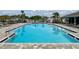 Large community pool with marked depths, lounge chairs, and meticulously kept pool deck at 11279 Amber Ridge Dr, Zellwood, FL 32798