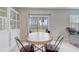 Bright dining area features an oval wood table, stylish chairs, built in hutch and sliding glass doors to the backyard at 11279 Amber Ridge Dr, Zellwood, FL 32798