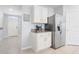 Kitchen features a stainless steel refrigerator, white cabinets and granite countertops at 11279 Amber Ridge Dr, Zellwood, FL 32798