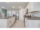 Kitchen with white cabinets, stainless steel appliances and granite countertops at 11279 Amber Ridge Dr, Zellwood, FL 32798