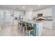 Kitchen with white cabinets, granite countertops, stainless steel appliances and a large island with barstool seating at 11279 Amber Ridge Dr, Zellwood, FL 32798