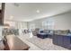 Inviting open-concept living space with tile flooring, blending kitchen, dining, and living areas at 11279 Amber Ridge Dr, Zellwood, FL 32798
