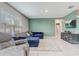 Open-concept living room with tile flooring, cozy furniture, and lots of natural light at 11279 Amber Ridge Dr, Zellwood, FL 32798