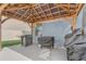 Outdoor patio with wooden pergola, string lights, and several outdoor cooking appliances at 11279 Amber Ridge Dr, Zellwood, FL 32798