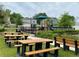 Community picnic area with multiple tables, benches, playground, and manicured landscape at 11279 Amber Ridge Dr, Zellwood, FL 32798