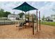 Community playground area with modern play structure, soft landing surface, and secure perimeter fencing at 11279 Amber Ridge Dr, Zellwood, FL 32798
