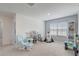 Spacious playroom provides plenty of room for activities and features abundant natural light at 11279 Amber Ridge Dr, Zellwood, FL 32798
