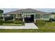 Community pool entrance with stone accents, lush landscaping, and secure gated access at 11279 Amber Ridge Dr, Zellwood, FL 32798