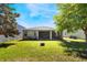 Large, grassy backyard with a screened lanai, bordered by a white fence, perfect for outdoor enjoyment at 1155 Seburn Rd, Apopka, FL 32703