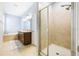 Bright bathroom featuring double sink vanity, soaking tub, and a tiled shower with glass door at 1155 Seburn Rd, Apopka, FL 32703