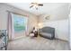 Lovely Bedroom with a crib, a rocking chair, a window with sheer curtains and carpet flooring at 1155 Seburn Rd, Apopka, FL 32703
