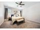 Cozy bedroom with carpet flooring, a ceiling fan, and a comfortable bed with a padded headboard at 1155 Seburn Rd, Apopka, FL 32703