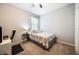 Simple bedroom with neutral colors, carpet flooring, and essential furnishings with a desk at 1155 Seburn Rd, Apopka, FL 32703