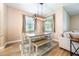 Cozy dining area features a wooden table, bench seating, and stylish light fixture at 1155 Seburn Rd, Apopka, FL 32703