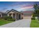 Charming single-story home showcasing a well-manicured lawn, neutral colors, and attached two-car garage at 1155 Seburn Rd, Apopka, FL 32703