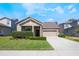 Charming single-story home with well-maintained lawn and lush landscaping, inviting curb appeal at 1155 Seburn Rd, Apopka, FL 32703
