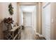 Long and bright hallway features wood floors and is tastefully decorated with elegant touches at 1155 Seburn Rd, Apopka, FL 32703
