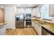 Bright kitchen boasts stainless steel appliances, granite countertops, and ample cabinet space at 1155 Seburn Rd, Apopka, FL 32703
