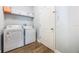 Practical laundry room with a washer, dryer, and storage shelving for efficient laundry management at 1155 Seburn Rd, Apopka, FL 32703