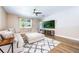 Comfortable living room with a large sectional couch, ceiling fan, and wood flooring at 1155 Seburn Rd, Apopka, FL 32703