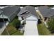 Aerial view of a single Gathering home featuring a two car garage and nice landscaping at 118 Hurst Ct, Deland, FL 32724