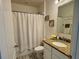 Bathroom with granite countertop, white cabinets, and a shower with a white curtain at 118 Hurst Ct, Deland, FL 32724