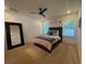 Bright bedroom featuring a ceiling fan and moon phase decor above the bed at 118 Hurst Ct, Deland, FL 32724