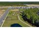 Aerial shot of a community featuring newly built homes, a park with walking trails, and a dog park at 13528 Autumn Harvest Ave, Winter Garden, FL 34787