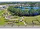 An aerial view of a community park, featuring a playground, green spaces, walking paths, and a dog park at 13528 Autumn Harvest Ave, Winter Garden, FL 34787