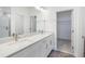 Modern bathroom featuring double vanity, white cabinets, and access to walk-in closet at 13528 Autumn Harvest Ave, Winter Garden, FL 34787