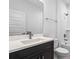 Bathroom featuring a tub and shower, a white marble countertop, and a dark wood vanity at 13528 Autumn Harvest Ave, Winter Garden, FL 34787