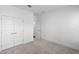 Bright bedroom with neutral carpet, white walls, and closet with double doors at 13528 Autumn Harvest Ave, Winter Garden, FL 34787
