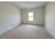 A bright, clean bedroom with a window providing natural light and a neutral color palette at 13528 Autumn Harvest Ave, Winter Garden, FL 34787