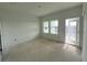 A bright bedroom features two windows and a door opening to the outside at 13528 Autumn Harvest Ave, Winter Garden, FL 34787