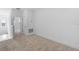 Bright bedroom with neutral carpet and white walls near a stairwell and window at 13528 Autumn Harvest Ave, Winter Garden, FL 34787