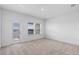 Bright bedroom with neutral carpet, white walls, and large window with balcony access at 13528 Autumn Harvest Ave, Winter Garden, FL 34787