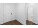 Bright entryway featuring wood-look flooring and a white door leading to a bathroom with tile floor and modern fixtures at 13528 Autumn Harvest Ave, Winter Garden, FL 34787