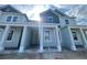 Charming two-story townhome featuring light blue siding, a covered porch, and bright natural light at 13528 Autumn Harvest Ave, Winter Garden, FL 34787