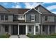 Attractive townhome with neutral-toned siding, a covered entrance, and a well-maintained lawn at 13528 Autumn Harvest Ave, Winter Garden, FL 34787