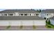 View of multiple garages showing the unit numbers and brick paved driveway at 13528 Autumn Harvest Ave, Winter Garden, FL 34787