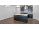 Kitchen with a large island featuring quartz countertop and stainless steel hood vent at 13528 Autumn Harvest Ave, Winter Garden, FL 34787