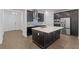 Stylish kitchen features a large center island with sink, stainless steel appliances, and ample cabinet space at 13528 Autumn Harvest Ave, Winter Garden, FL 34787