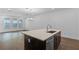 Open kitchen island with a stainless steel dishwasher and a sink with quartz countertop at 13528 Autumn Harvest Ave, Winter Garden, FL 34787