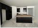 Contemporary kitchen featuring an island and dark cabinetry with stainless steel hardware at 13528 Autumn Harvest Ave, Winter Garden, FL 34787