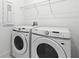 Bright laundry room with modern Samsung washer and dryer, plus ample storage space at 13528 Autumn Harvest Ave, Winter Garden, FL 34787